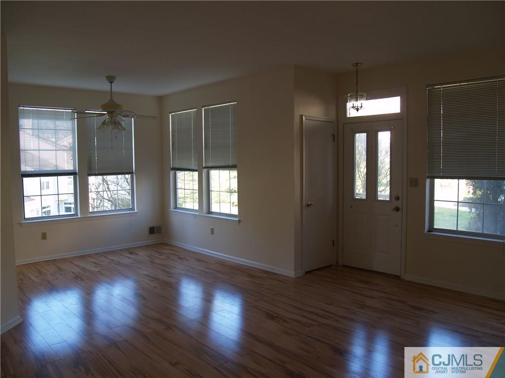 18 High Pond Lane, Unit 18 Bedminster, NJ 07921 - Photo 5 of 19 a view of an empty room with wooden floor and a window