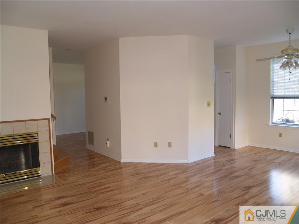 18 High Pond Lane, Unit 18 Bedminster, NJ 07921 - Photo 6 of 19 an empty room with wooden floor and fireplace
