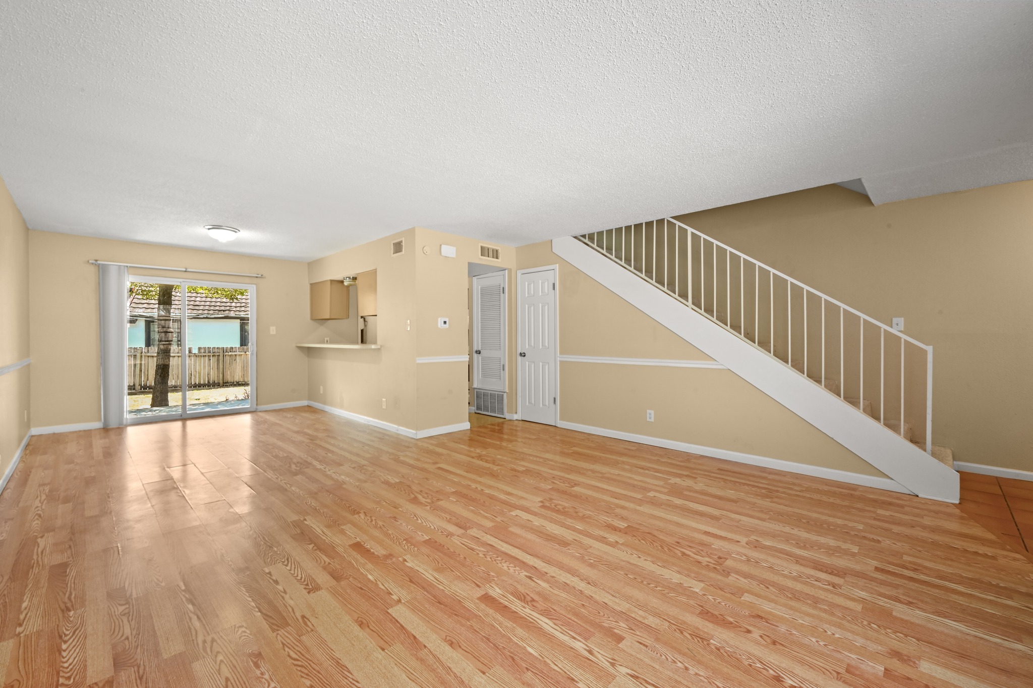 807 Castle Ridge Road, Unit C Austin, TX 78746 - Photo 8 of 26 Gleaming hardwood floors and a modern staircase anchor this open and airy living area.