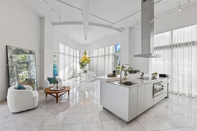 a view of kitchen with stainless steel appliances granite countertop a sink and a refrigerator