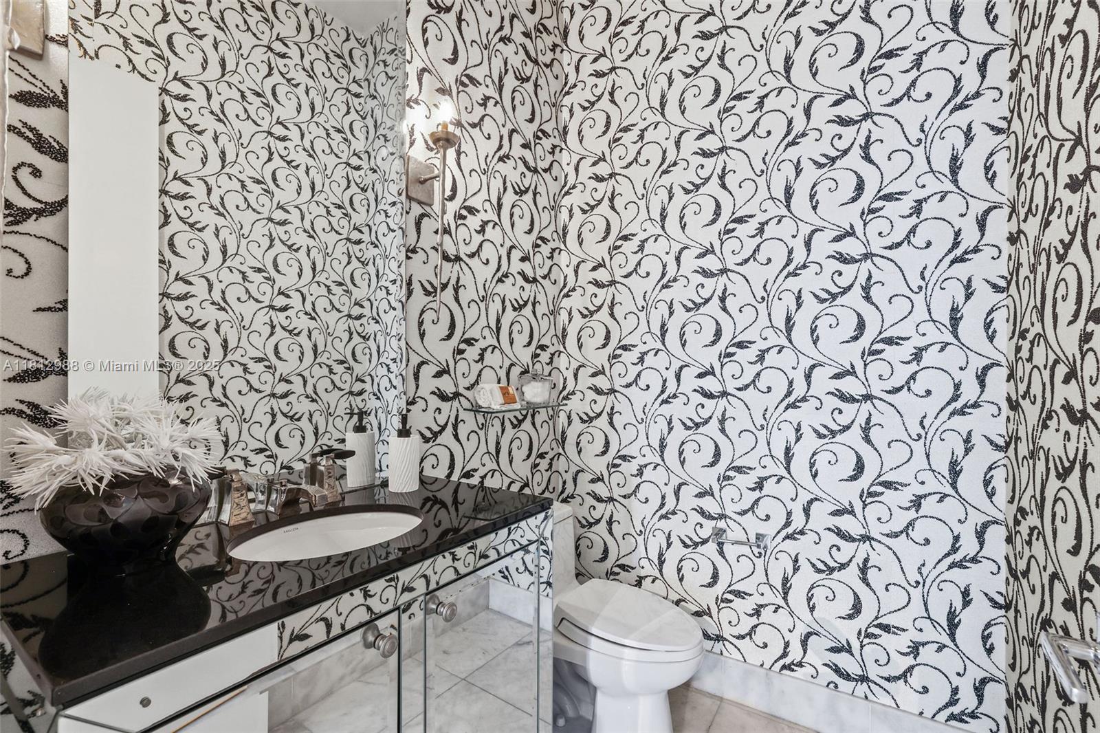 2001 Meridian Avenue, Unit 101 Miami Beach, FL 33139 - Photo 36 of 59 a bathroom with a granite countertop toilet and a sink