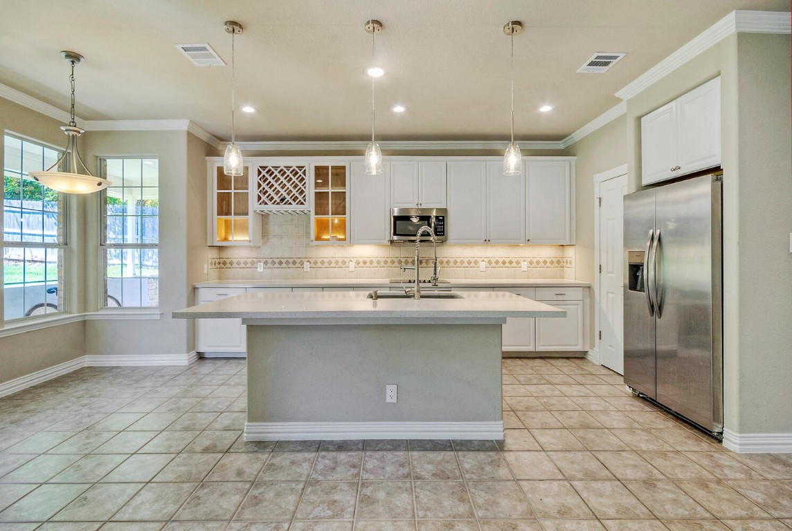 Updated kitchen with quartz countertops, stainless steel appliances and updated light fixtures.