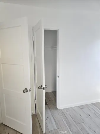 a view of hallway with wooden floor