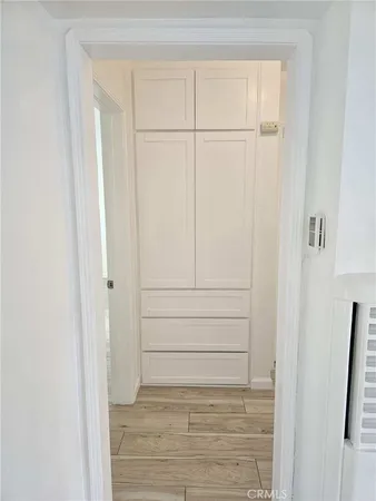 a view of a hallway with wooden floor