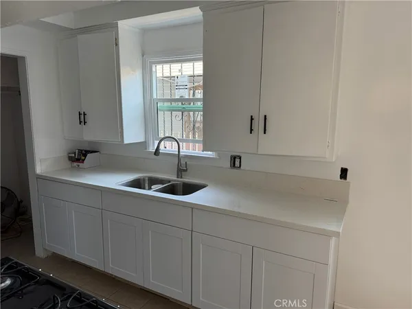 a kitchen with a sink and cabinets