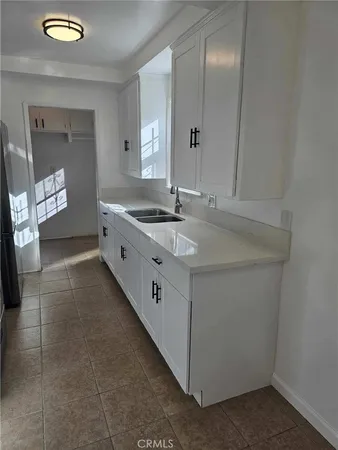 a kitchen with sink and cabinets