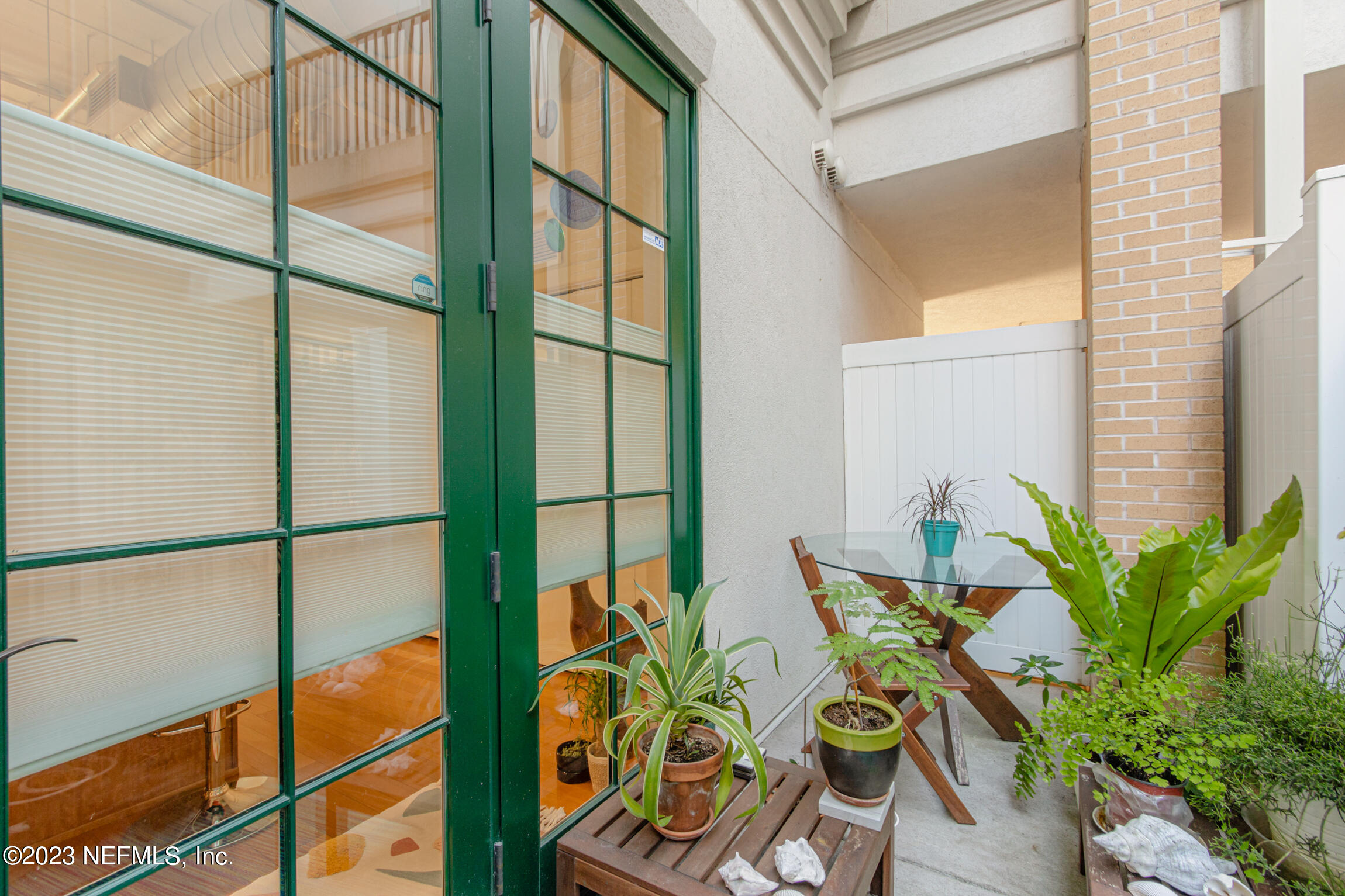 1661 Riverside Avenue, Unit 110 Jacksonville, FL 32204 - Photo 22 of 47 a vase of flowers sitting on a table with wooden floor