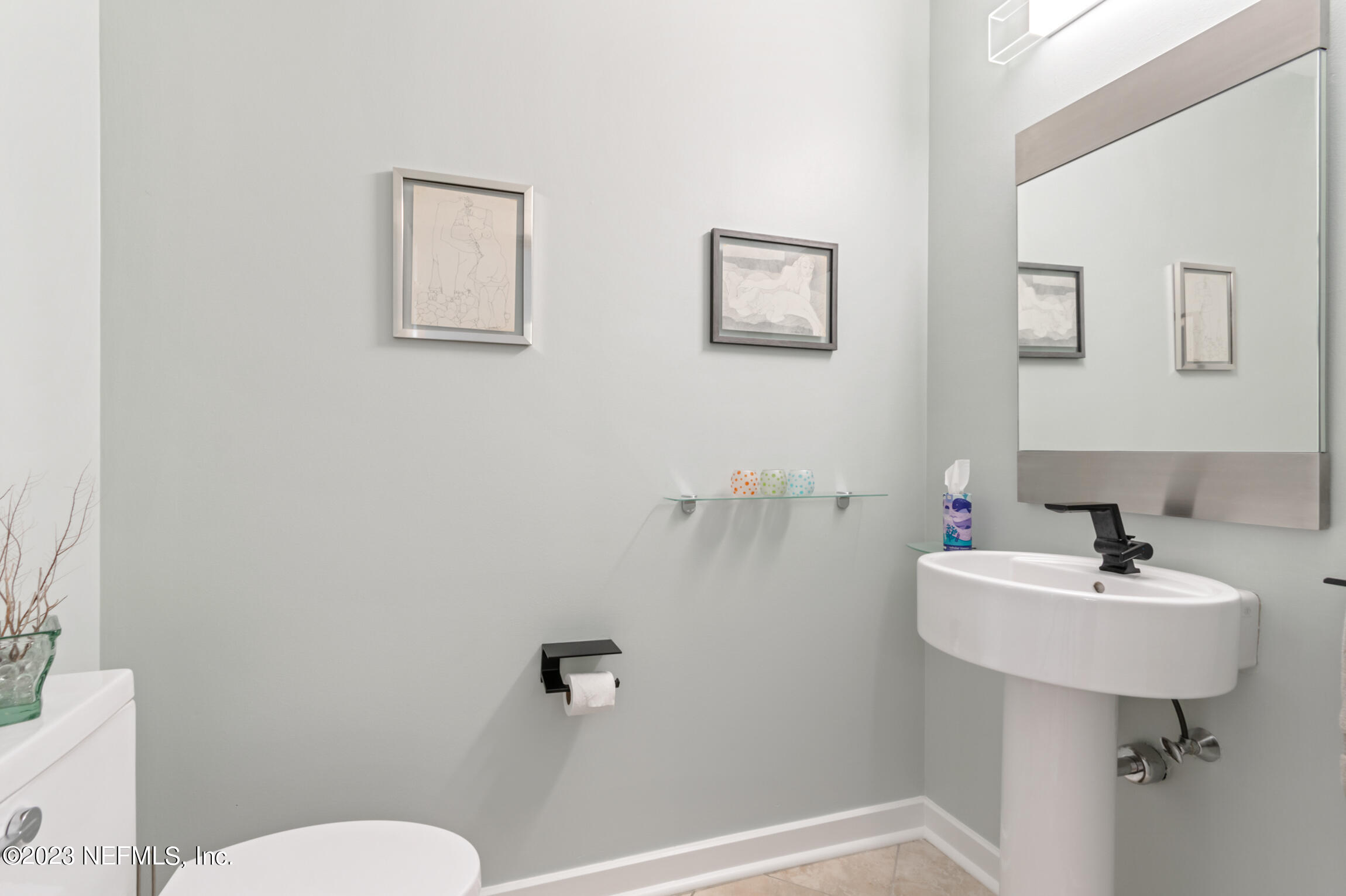 1661 Riverside Avenue, Unit 110 Jacksonville, FL 32204 - Photo 27 of 47 a bathroom with a sink a toilet and mirror