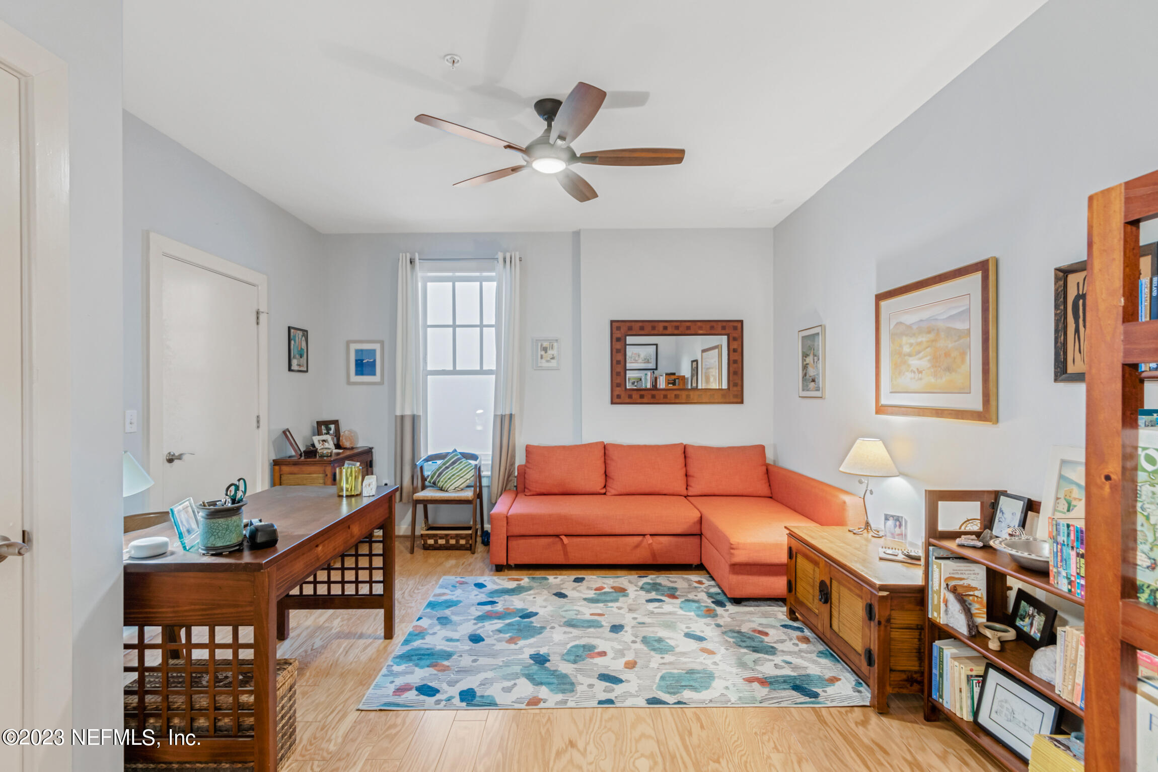1661 Riverside Avenue, Unit 110 Jacksonville, FL 32204 - Photo 35 of 47 a living room with furniture rug and wooden floor