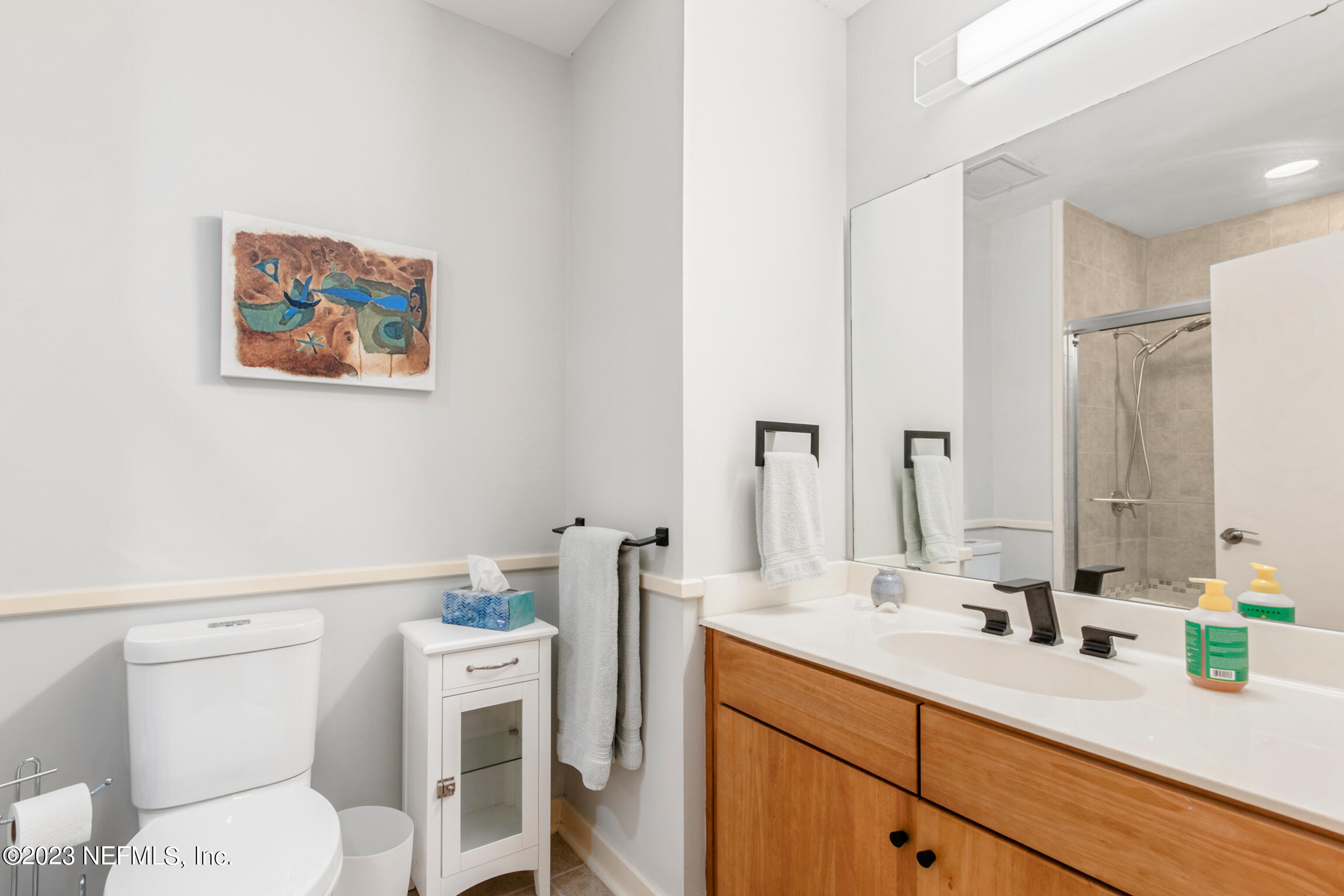 1661 Riverside Avenue, Unit 110 Jacksonville, FL 32204 - Photo 37 of 47 a bathroom with a toilet a sink and a mirror