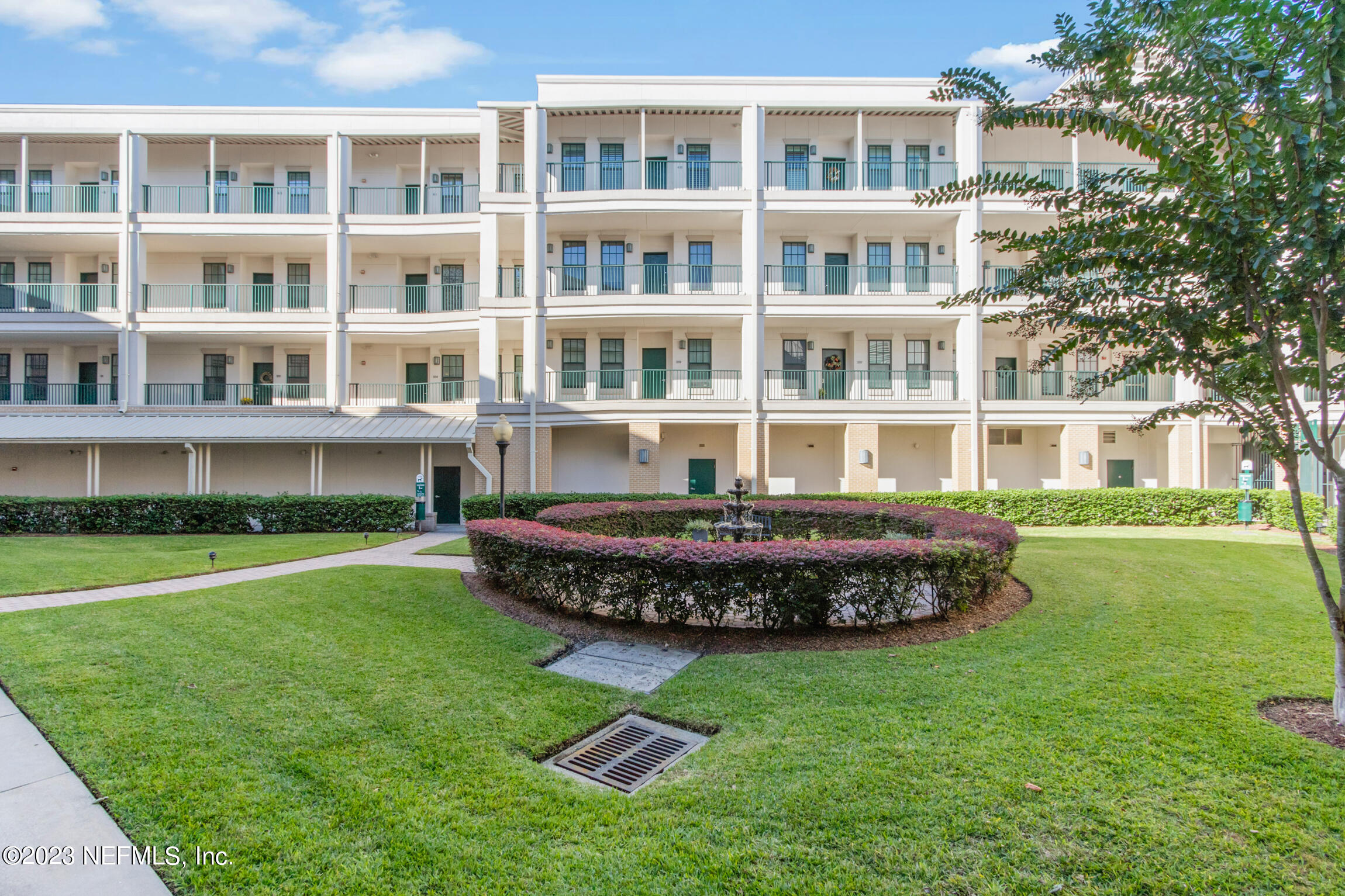 1661 Riverside Avenue, Unit 110 Jacksonville, FL 32204 - Photo 8 of 47 a front view of a building with a garden