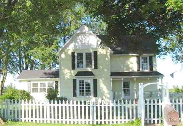 7206 North Crossroads Road Lena, IL 61048 - Photo 1 of 12 a front view of a house with a garden