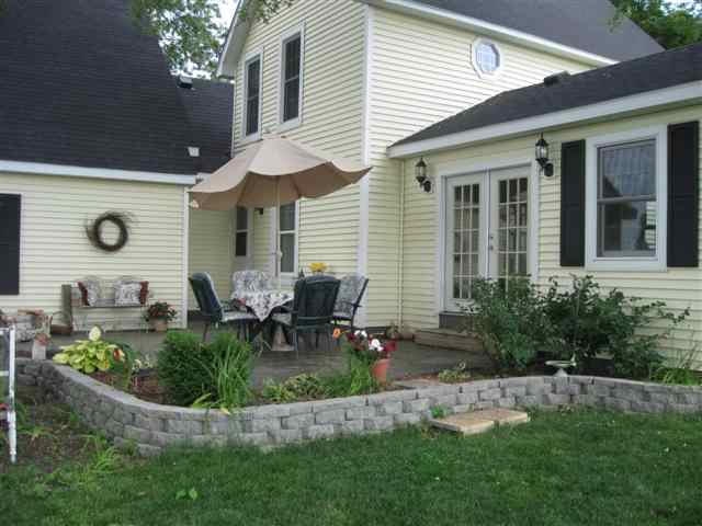 7206 North Crossroads Road Lena, IL 61048 - Photo 2 of 12 a view of house with backyard and sitting area