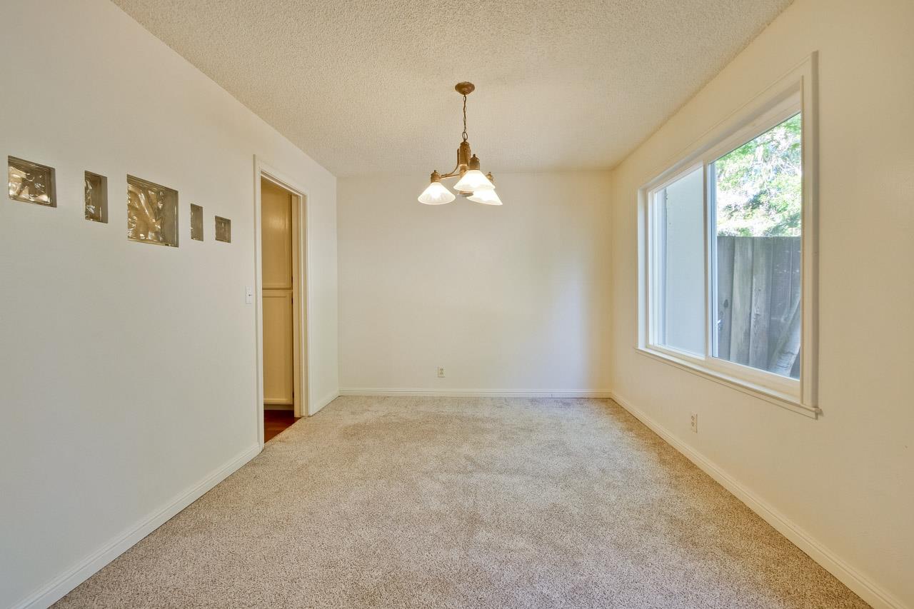 22903 Longdown Road Cupertino, CA 95014 - Photo 12 of 42 an empty room that has a window and kitchen view