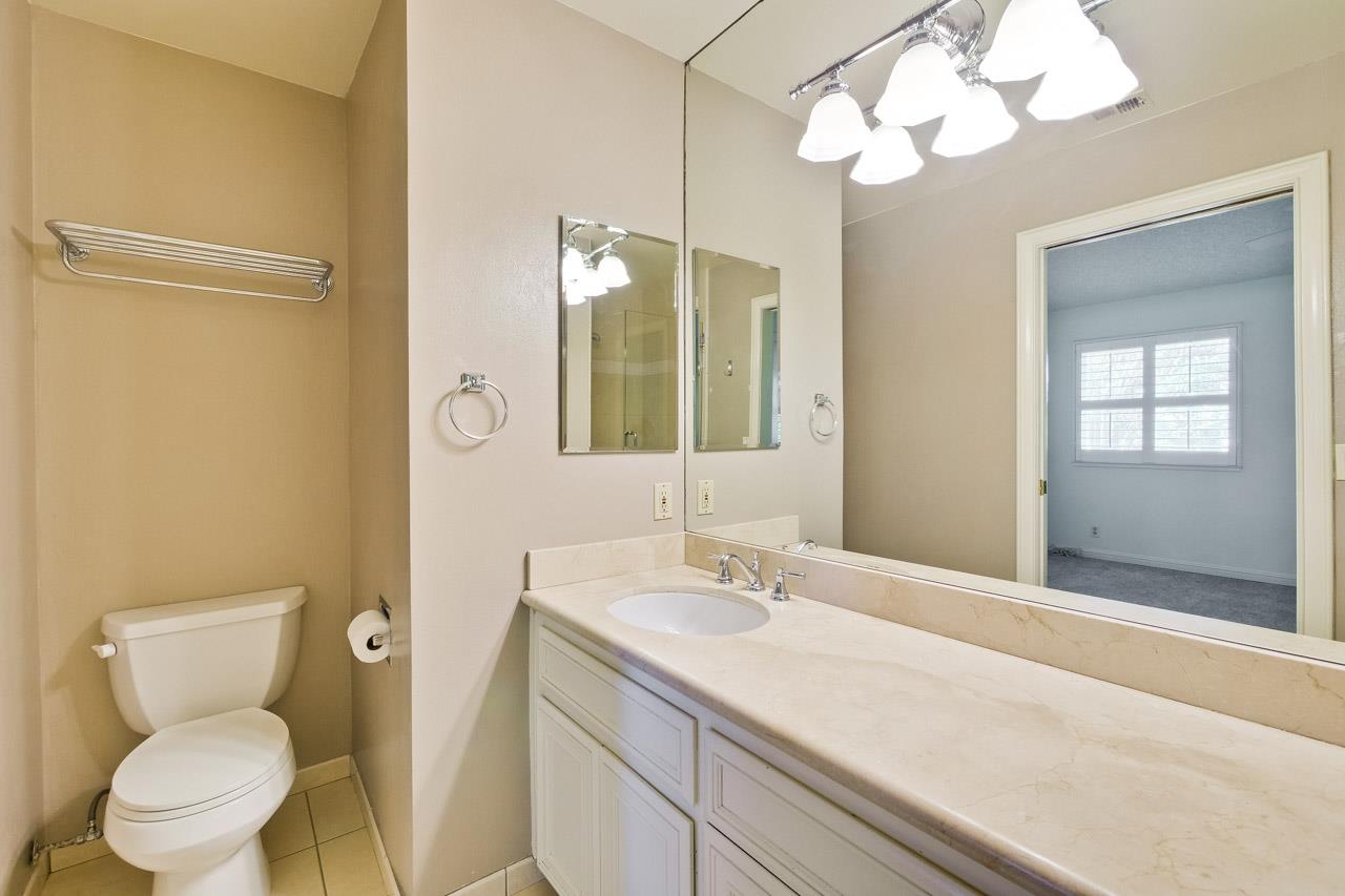 22903 Longdown Road Cupertino, CA 95014 - Photo 20 of 42 a bathroom with a toilet a sink and a mirror