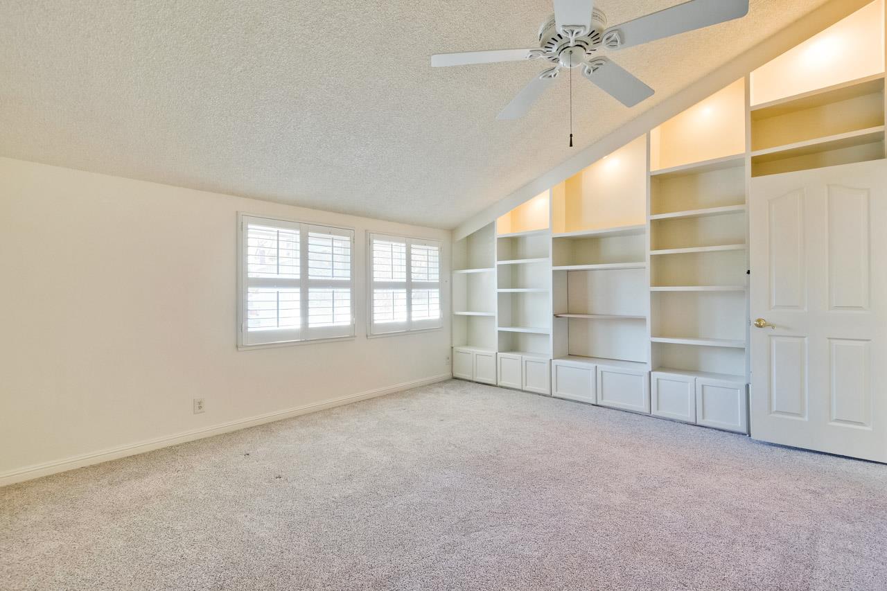 22903 Longdown Road Cupertino, CA 95014 - Photo 21 of 42 an empty room with a empty shelves and natural light