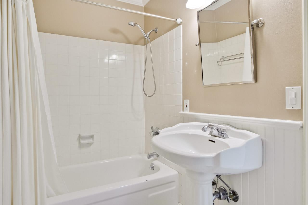 22903 Longdown Road Cupertino, CA 95014 - Photo 24 of 42 a bathroom with a white bath tub sitting next to a white sink and a shower