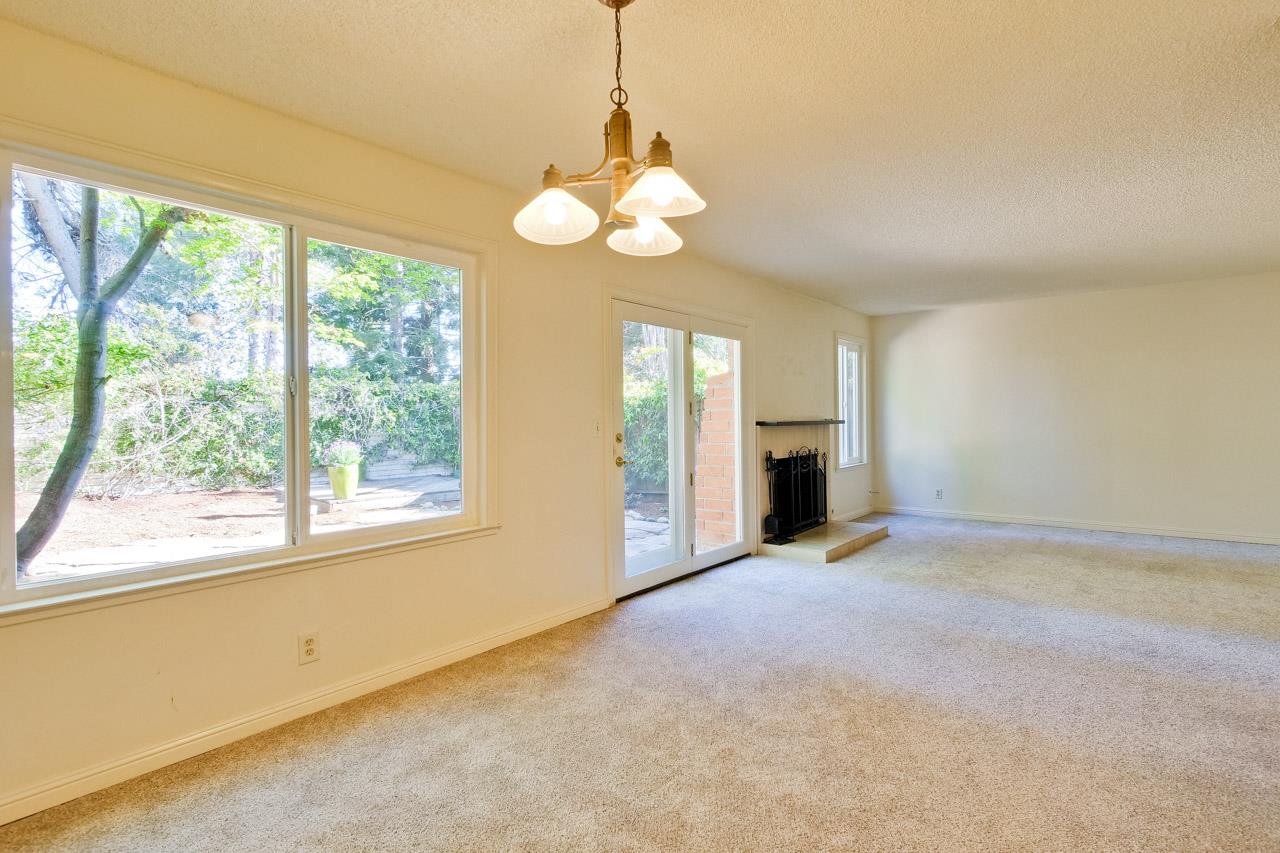 22903 Longdown Road Cupertino, CA 95014 - Photo 9 of 42 a view of an empty room with a window and fireplace