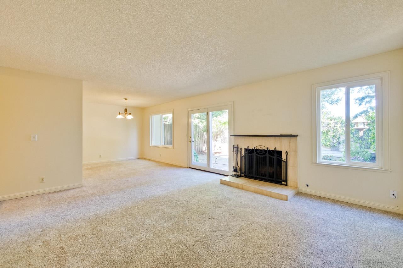 22903 Longdown Road Cupertino, CA 95014 - Photo 10 of 42 an empty room with windows and fireplace