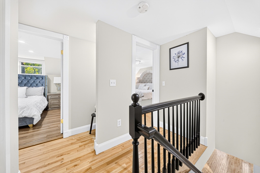 24 Miller Road Wilmington, MA 01887 - Photo 20 of 40 a view of a hallway with wooden floor and bedroom