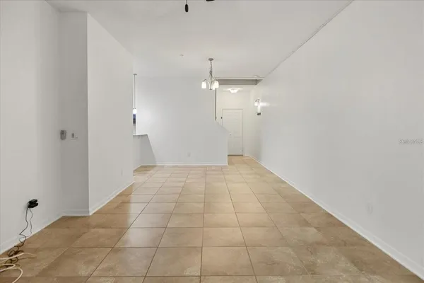 an empty room with wooden floor and mirror