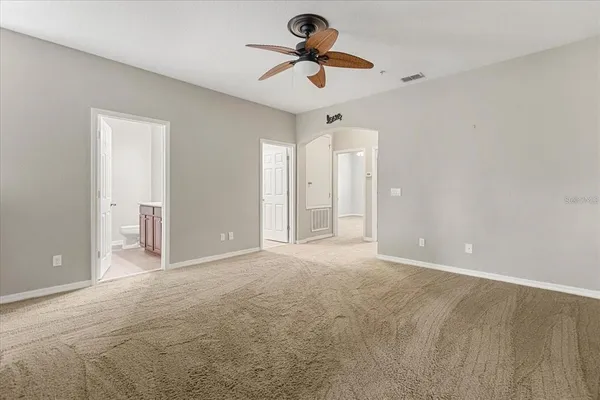 an empty room with a white wall & dryer