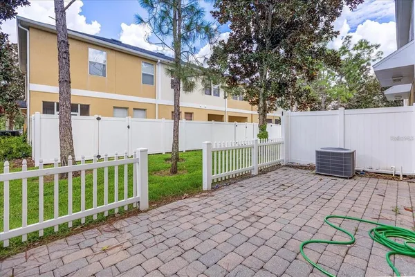 an aerial view of a house with a yard and lake view