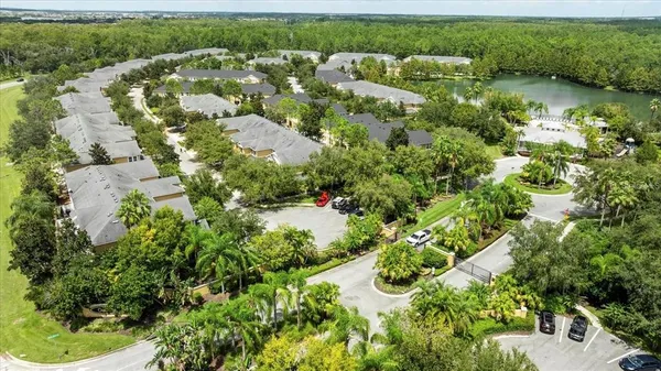 an aerial view of a house with a yard and lake view