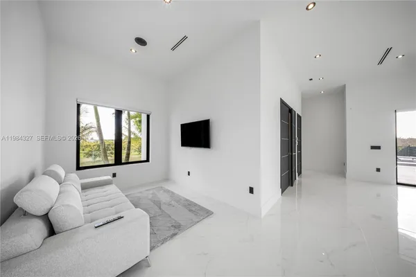 a view of living room with furniture and a chandelier
