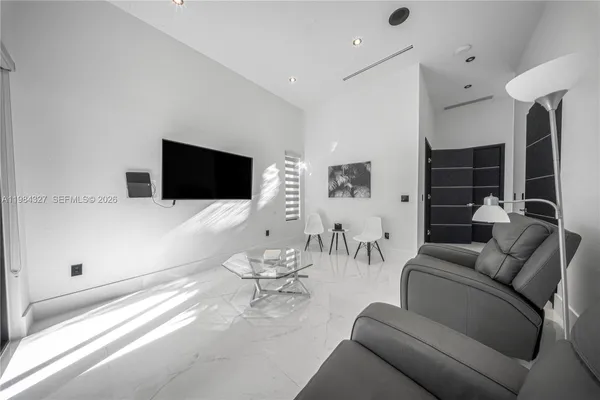 a living room with furniture and a flat screen tv