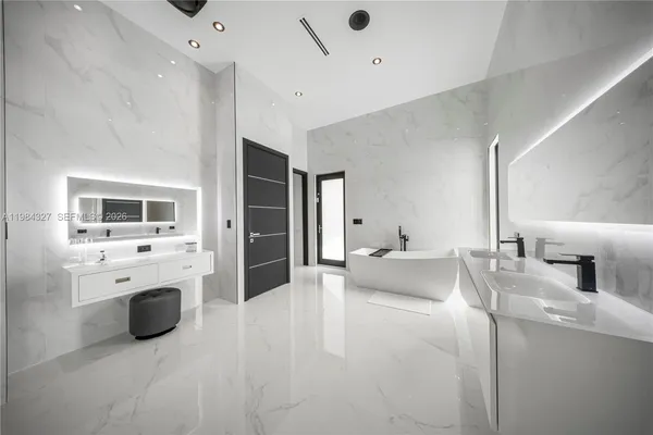 a bathroom with a double vanity sink a toilet and shower