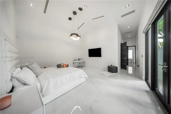 a large white kitchen with a large window