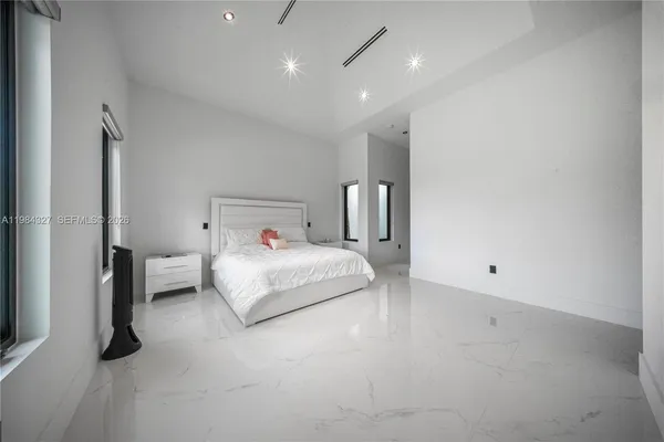 a room with a large window and furniture