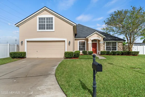 a front view of a house with a yard and garage