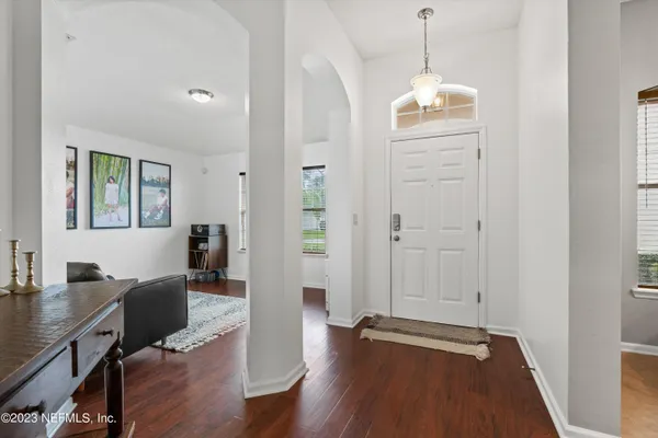 a view of a workspace with wooden floor and windows