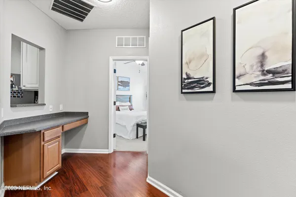 a view of kitchen with cabinets and wooden floor