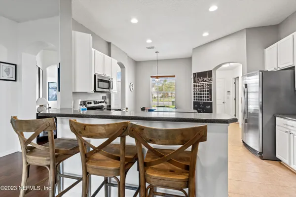 a dining table chair refrigerator and microwave