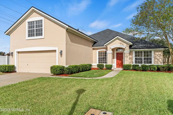 a view of a hallway with wooden floor and entryway