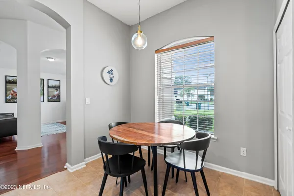 a view of a dining room with furniture and wooden floor