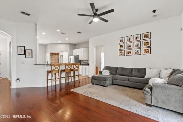 a living room with furniture and wooden floor