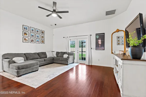 a living room with furniture and a flat screen tv