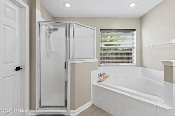 a bathroom with bathtub and a shower