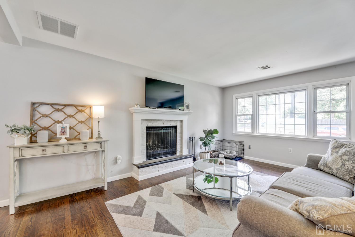 199 Jordan Road Colonia, NJ 07067 - Photo 4 of 24 a living room with furniture a fireplace and a flat screen tv