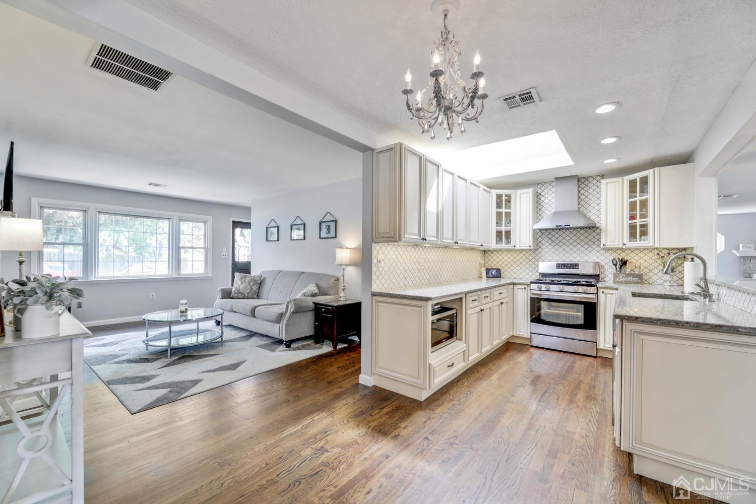 199 Jordan Road Colonia, NJ 07067 - Photo 8 of 24 a large white kitchen with stainless steel appliances
