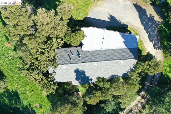 an aerial view of a house with a yard