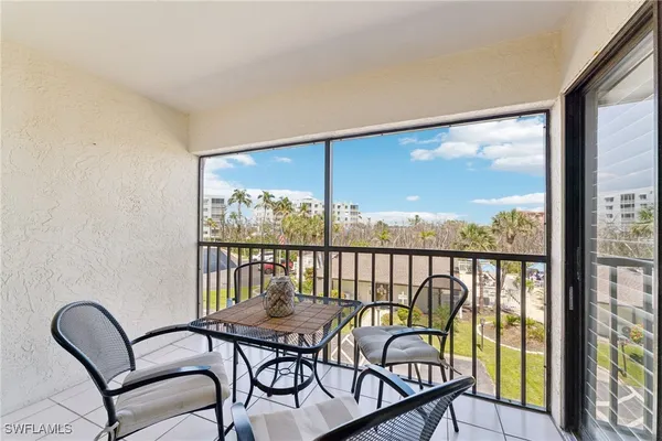 a view of a balcony with chairs