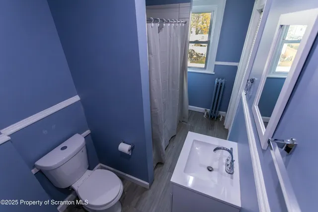 a white toilet sitting next to a sink
