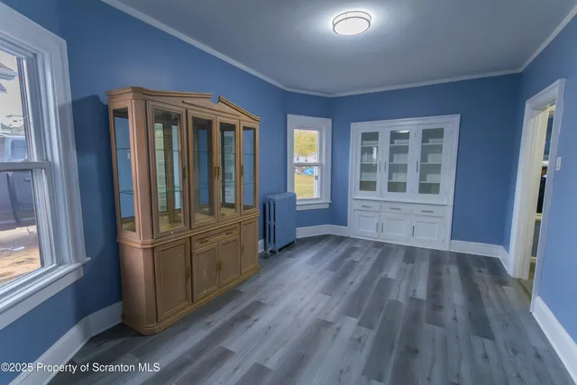 a kitchen with stainless steel appliances granite countertop a refrigerator sink and wooden floor