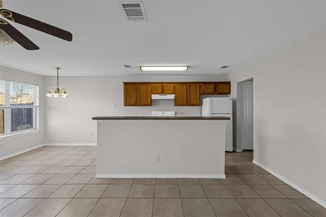a view of a kitchen with microwave and cabinets