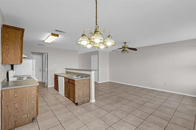 a kitchen that has a sink a stove and a oven